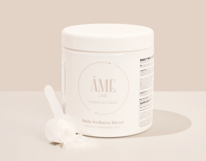 The Hydrate & Create jar beside its scoop of unflavored powder